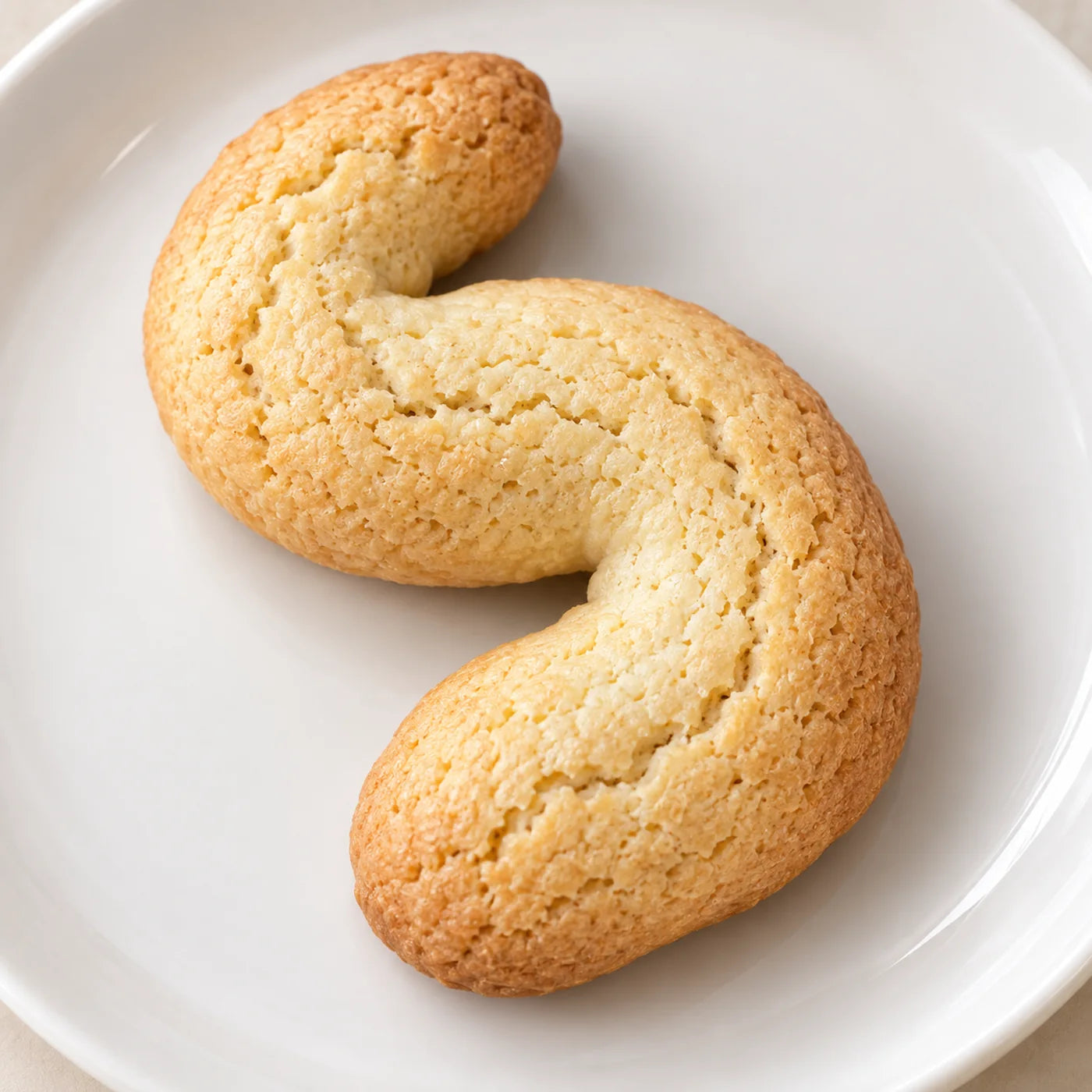Italian S cookie, a crisp S-shaped butter cookie baked golden at the edges, from the Buon Cibo dolci case